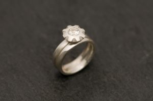 White topaz wedding set featuring topaz flower ring and wedding band in sterling silver