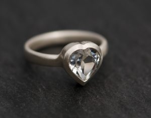 Heart shaped white topaz, set in satin finished sterling silver. This is a really pretty topaz ring.