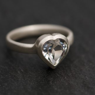Heart shaped white topaz, set in satin finished sterling silver. This is a really pretty topaz ring.