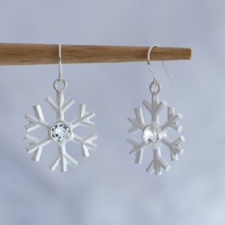 A perfect winter gift. White topaz snowflake earrings, set in sterling silver. Snowflake 20mm across, stone 5mm. Designed and handmade by William White, UK