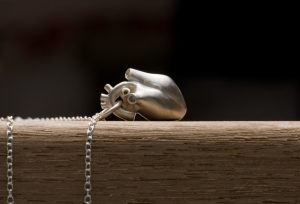 Solid silver anatomical heart 'killer charm' pendant, on a fine silver chain necklace. Made by William White