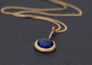 Brigh blue sapphire lollipop pendant on 18k yellow gold chain by William White