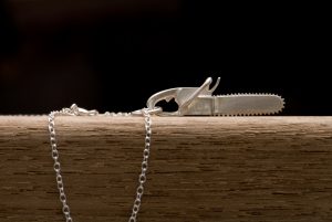 Silver chainsaw 'killer charm' pendent on a fine silver chain necklac by William White