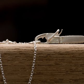 Silver chainsaw 'killer charm' pendent on a fine silver chain necklac by William White