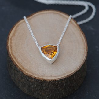 Simple Citrine trillion pendant in satin finished sterling silver. Available with 16″ or 18″ chain. Designed and handmade by William White in Cornwall, UK