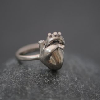18k white gold anatomical heart set with tiny diamonds on simple ring band