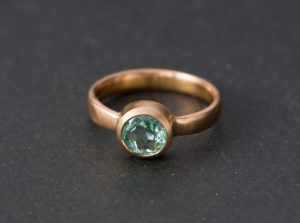 Pale green Columbian emerald set in rose gold ring