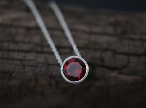 Deep red garnet necklace in satin finished sterling silver on silver chain. Made by William White