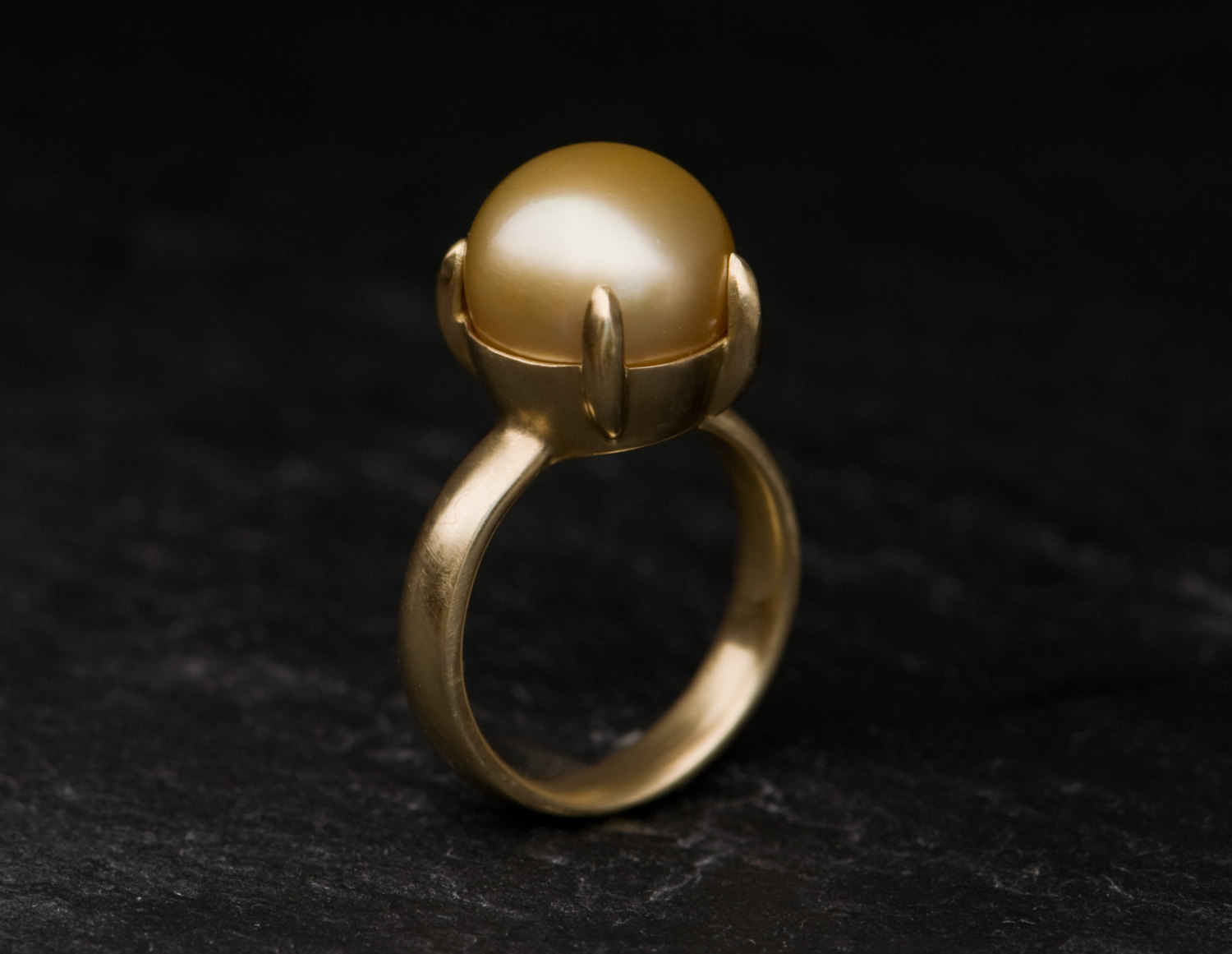 large gold pearl claw set in gold ring