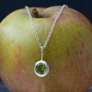 Peridot lollipop, set in satin finished sterling silver on a silver chain.