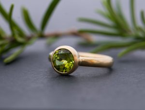 Peridot solitaire ring in yellow gold
