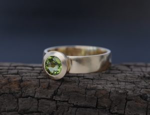 green peridot solitaire ring in 18k yellow gold