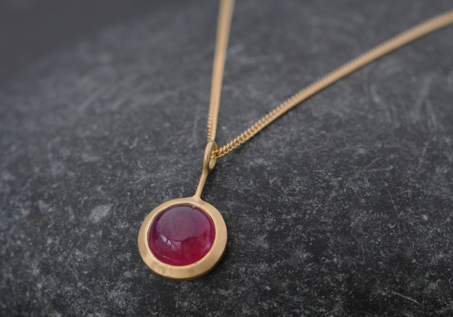 Beautiful Ruby 'Lollipop' necklace, set in 18k Yellow Gold. Fracture filled ruby cabochon is 8mm across and 3 carats by William White