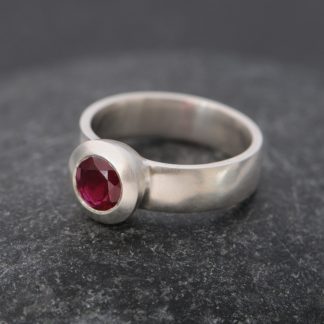 Ruby solitaire set in silver ring
