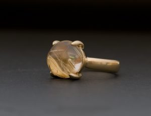 Large rutilated quartz stone claw set in 18k gold ring