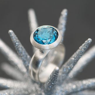 Bright Swiss blue topaz solitaire ring in sterling silver