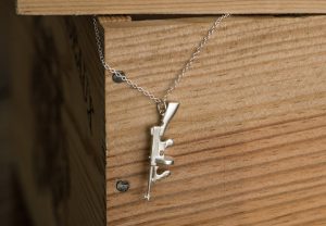 Tommy gun 'killer charm' in satin finished solid silver, on fine silver chain. By William White
