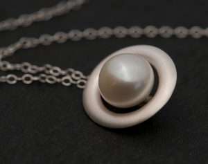 White pearl halo necklace in satin finished sterling silver. Made by William White