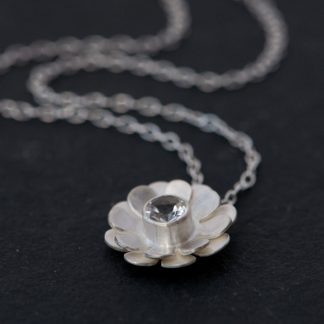 Pretty White Topaz daisy design, set in satin finished sterling silver on a silver chain. Designed and handmade by William White in Cornwall, UK.