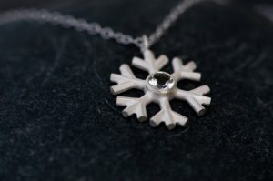 White topaz snowflake, set in sterling silver on a fine silver necklace. By William White