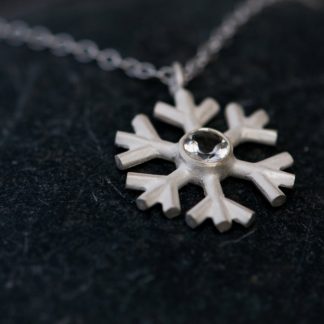 White topaz snowflake, set in sterling silver on a fine silver necklace. By William White