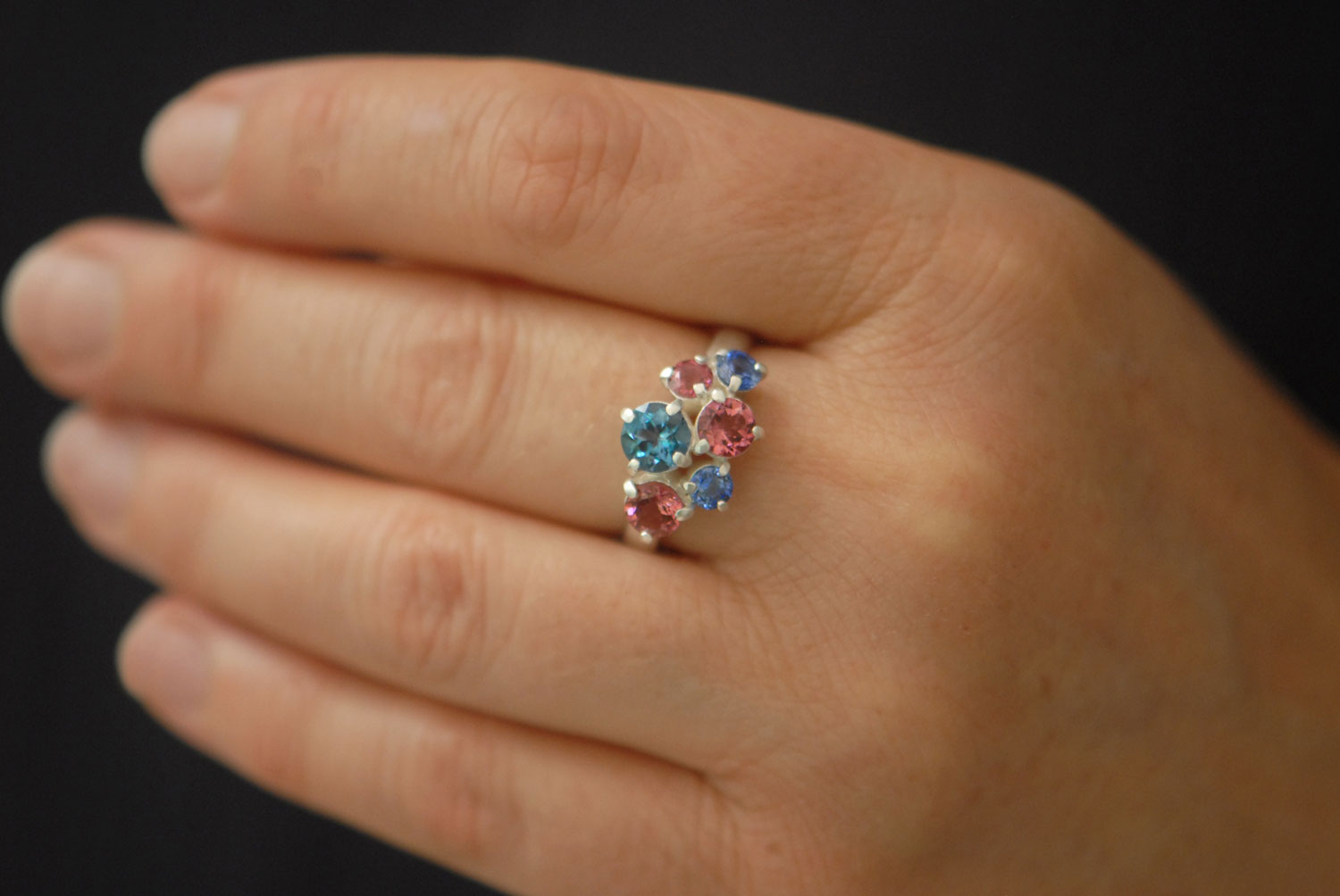 Topaz,-tourmailne-and-sapphire-cluster-ring-in-silve-on-hand-2