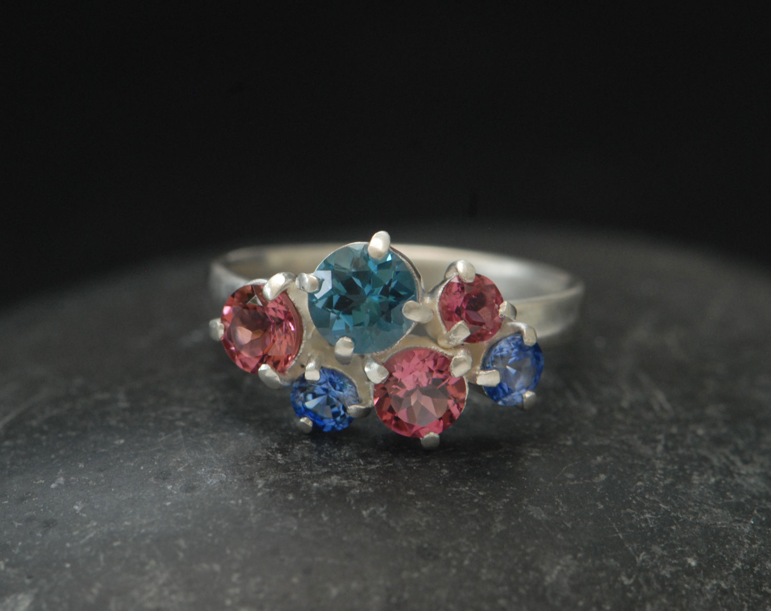 Topaz,-tourmailne-and-sapphire-cluster-ring-in-silver-front