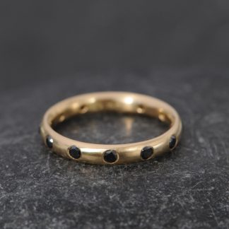 Black diamond eternity ring in gold