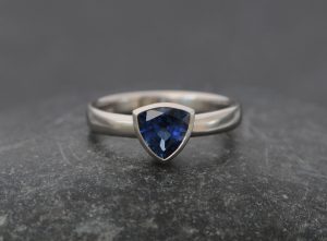Blue Sapphire trillion stone in a platinum band