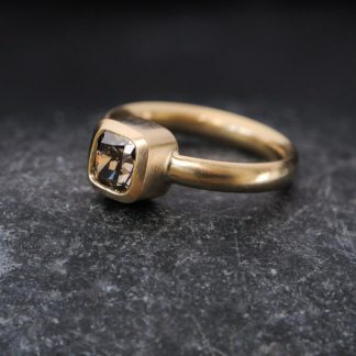 chocolate diamond solitaire ring in gold on dark background