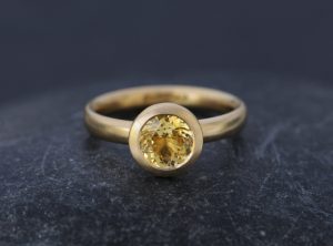 18K Gold ring with yellow sapphire solitaire stone. A contemporary design