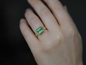 green tourmaline ring set in satin finished 18k yellow gold on hand
