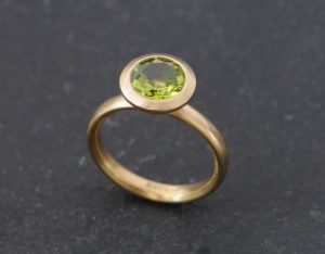 peridot 8mm halo ring in 18K y gold