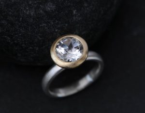 white topaz halo ring in 18K y gold and silver band