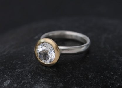 white topaz halo ring in 18K y gold and silver band