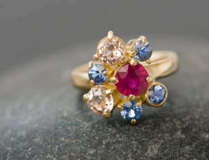 ruby and sapphire cluster ring in gold.