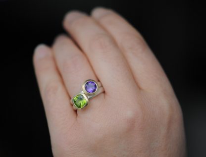 peridot and purple amethyst stacking rings on hand