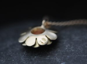 Ruby daisy necklace in 18K yellow gold.