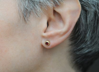 ruby 4mm stud earrings 18K yellow gold on ear