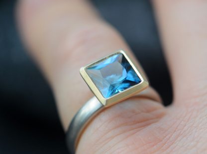 London blue topaz 8mm princess cut mixed metal ring on hand
