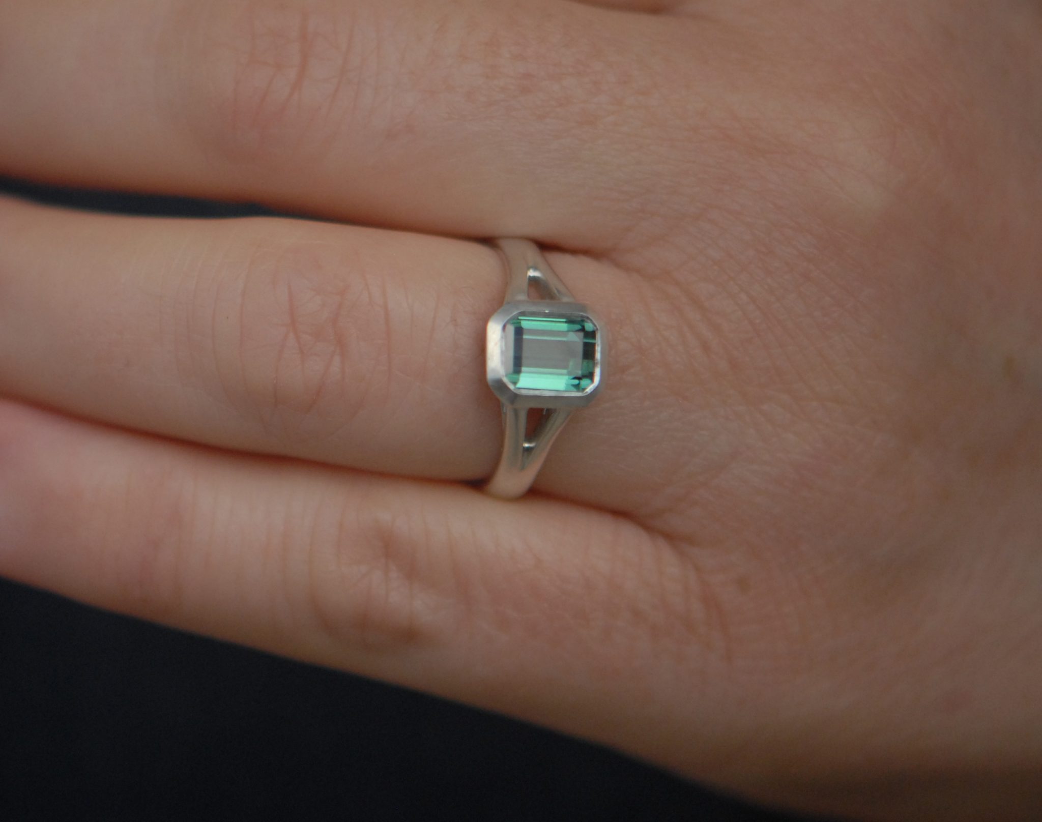 green tourmaline octagon cut split shank ring in silver on hand 2