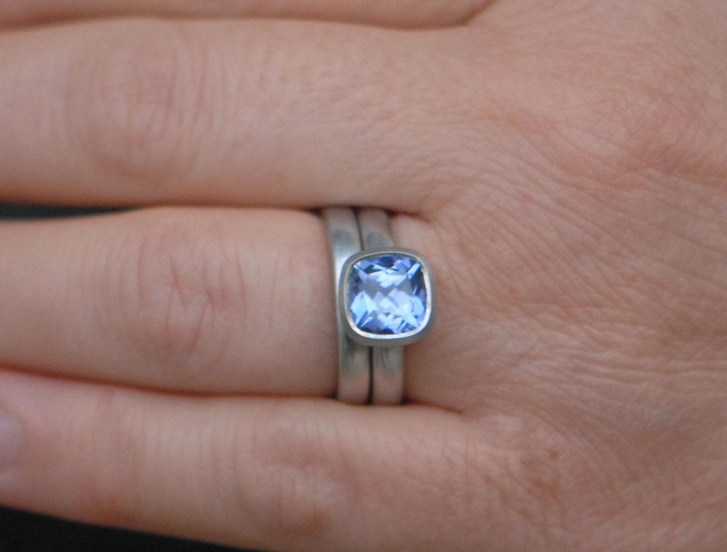lab-sapphire-light-blue-8mm-cushion-cut-wedding-set-in-platinum-on-hand