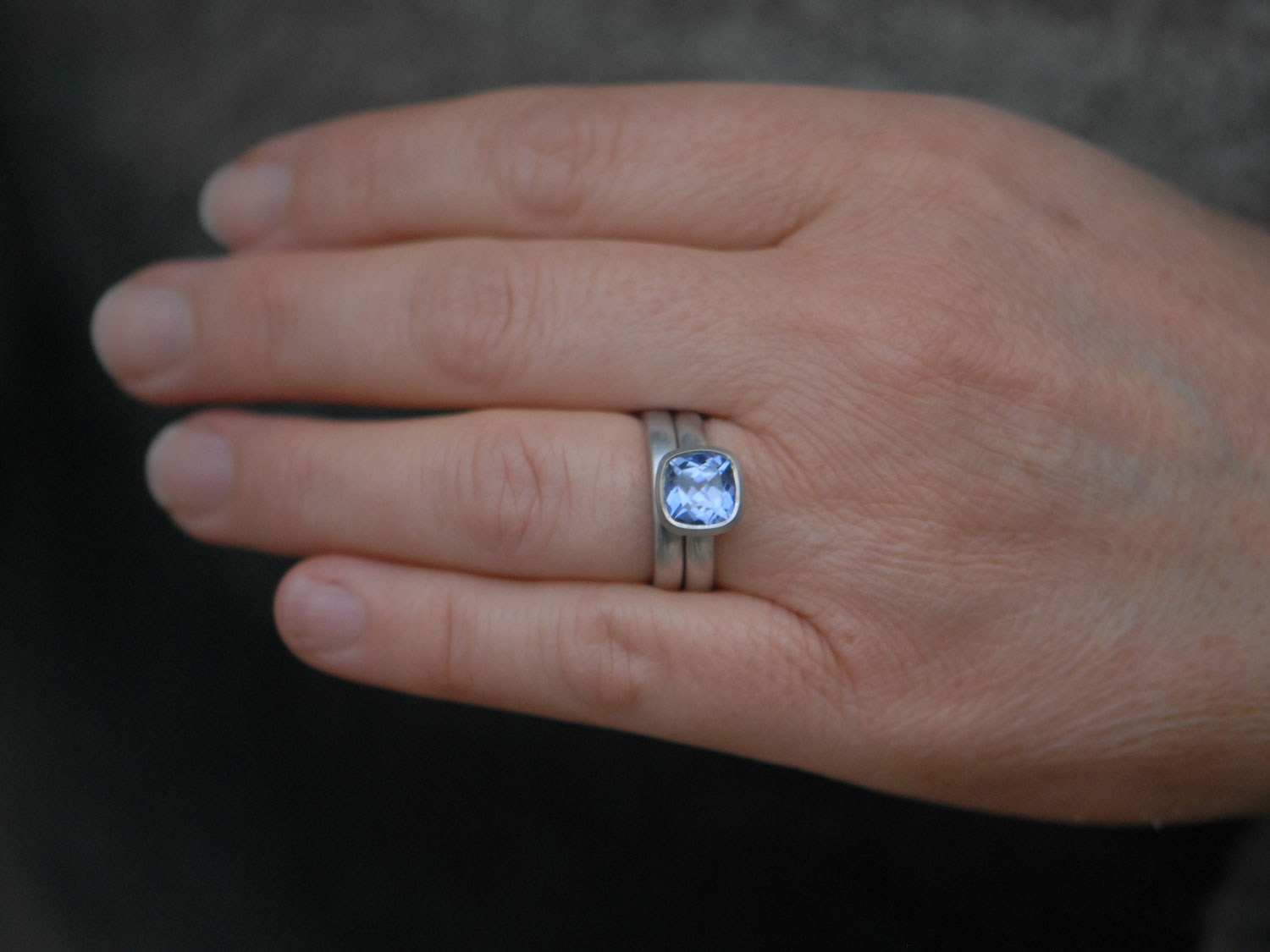 lab-sapphire-light-blue-8mm-cushion-cut-wedding-set-in-platinum-on-hand