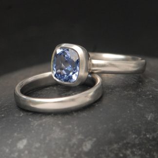lab-sapphire-light-blue-8mm-cushion-cut-wedding-set-in-platinum-on-hand