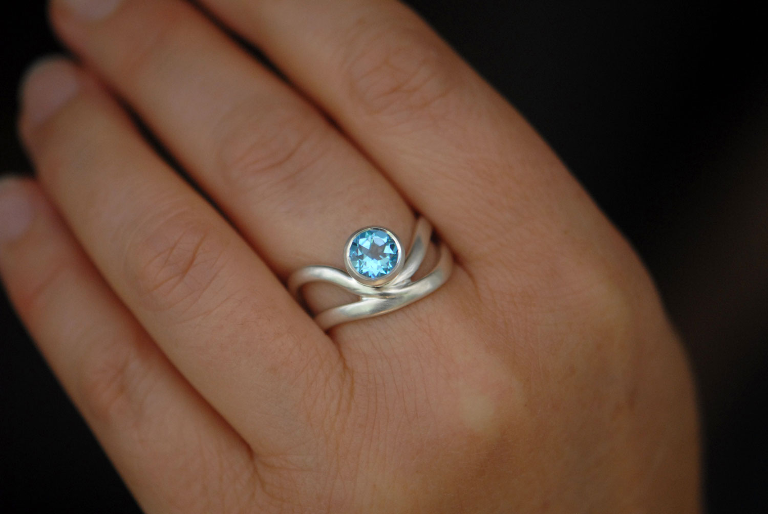 swiss-blue-topaz-wave-ring-in-silver-on-hand-2