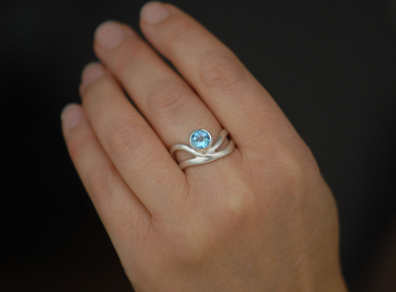 swiss-blue-topaz-wave-ring-in-silver-on-hand-3