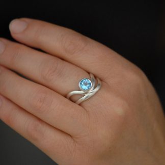 swiss-blue-topaz-wave-ring-in-silver-on-hand-2