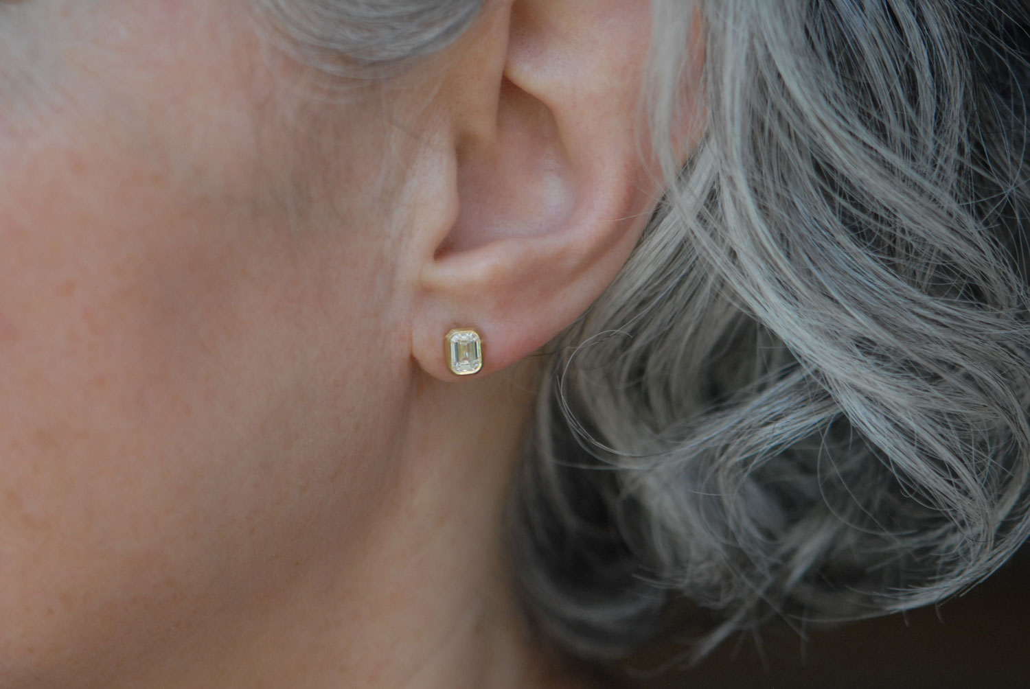 lab-diamond-octagon-cut-stud-earrings-in-18K-yellow-gold-on-ear-2
