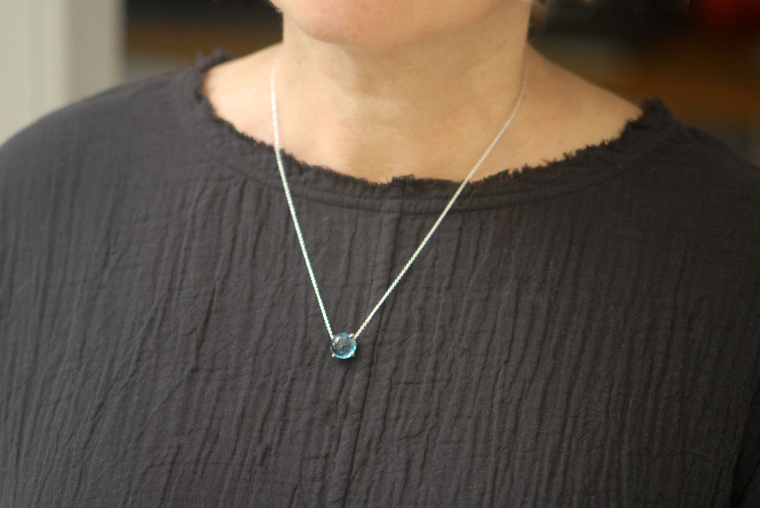 London-blue-topaz-cab-10mm-dragons-eye-necklace-silver-on-neck